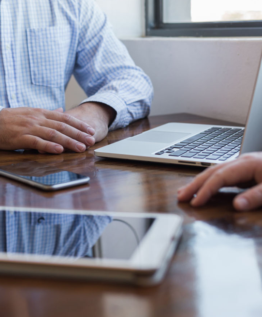 Image of men at desk with mobile devices