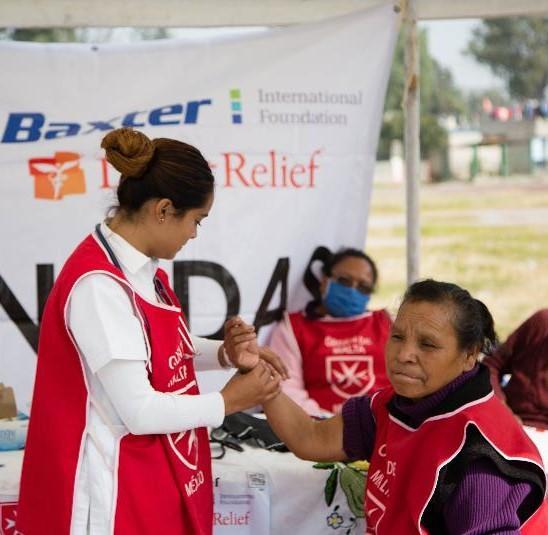 Volunteer Aid assisting at Health Clinic